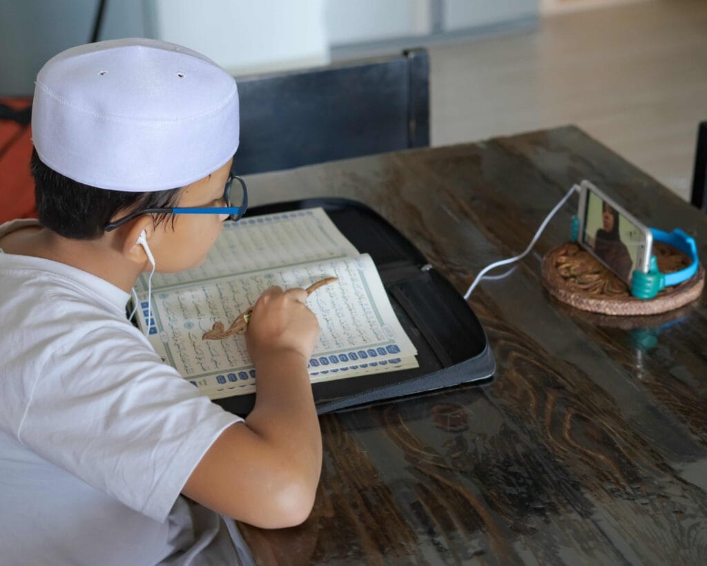 Kids Online Quran Classes 4 asian-kid-reading-al-quran-through-video-call-onlineclass-scaled