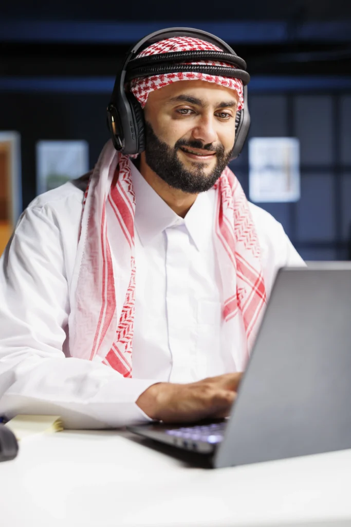 Home 9 Man using laptop with headphones on.