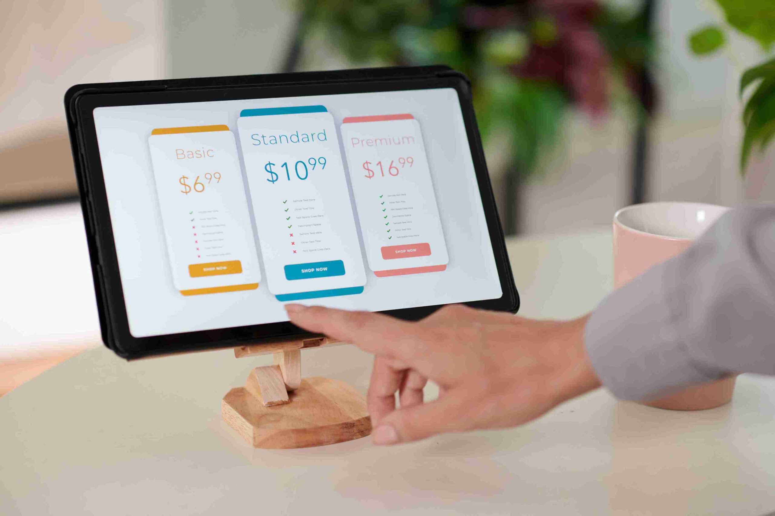 Female Quran Teacher Online for Ladies 4 Hand of young female customer pointing at model of smartphone on tablet screen