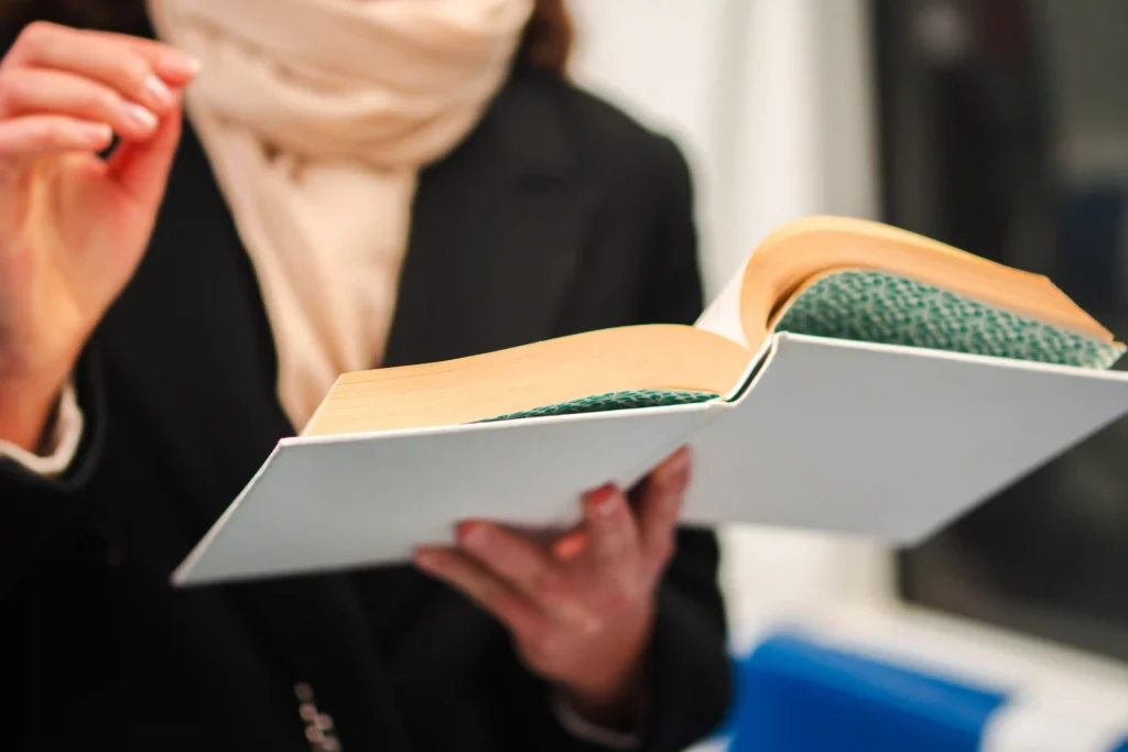 Home 7 a focused young woman reading an open book