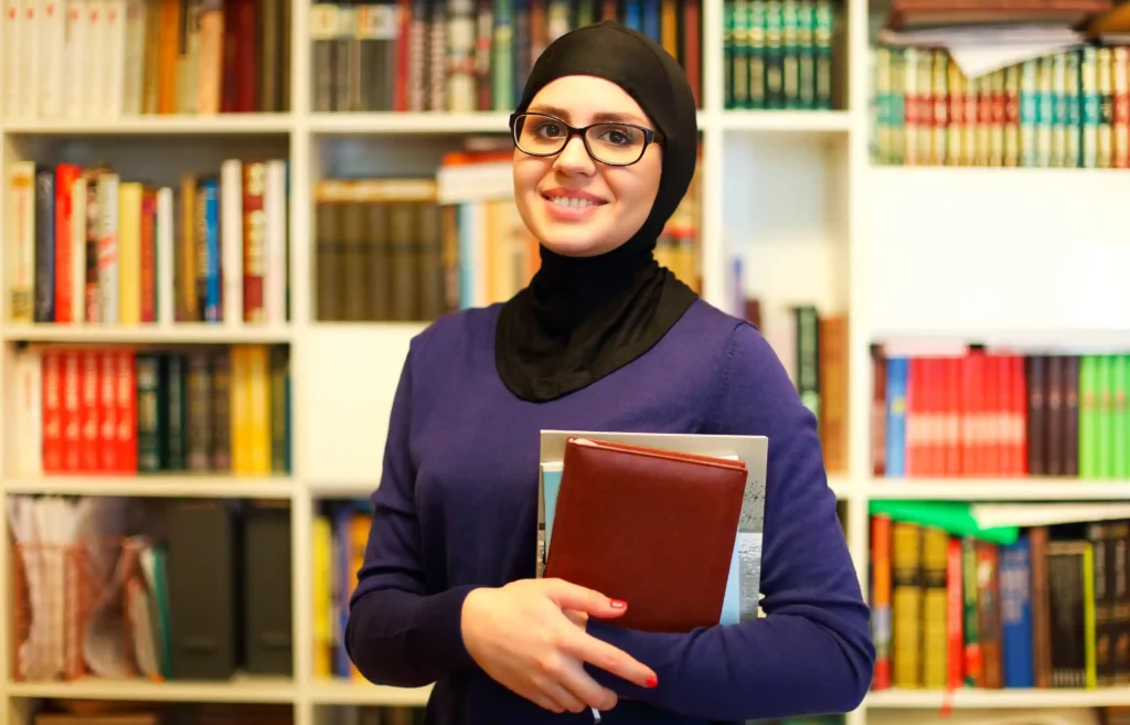 Female Quran Teacher Online for Ladies 3 smiling islamic student with books in library