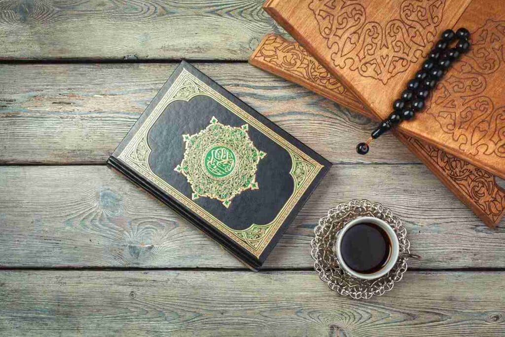Top view of Quran with coffee cup and tasbih on a rustic wooden table
