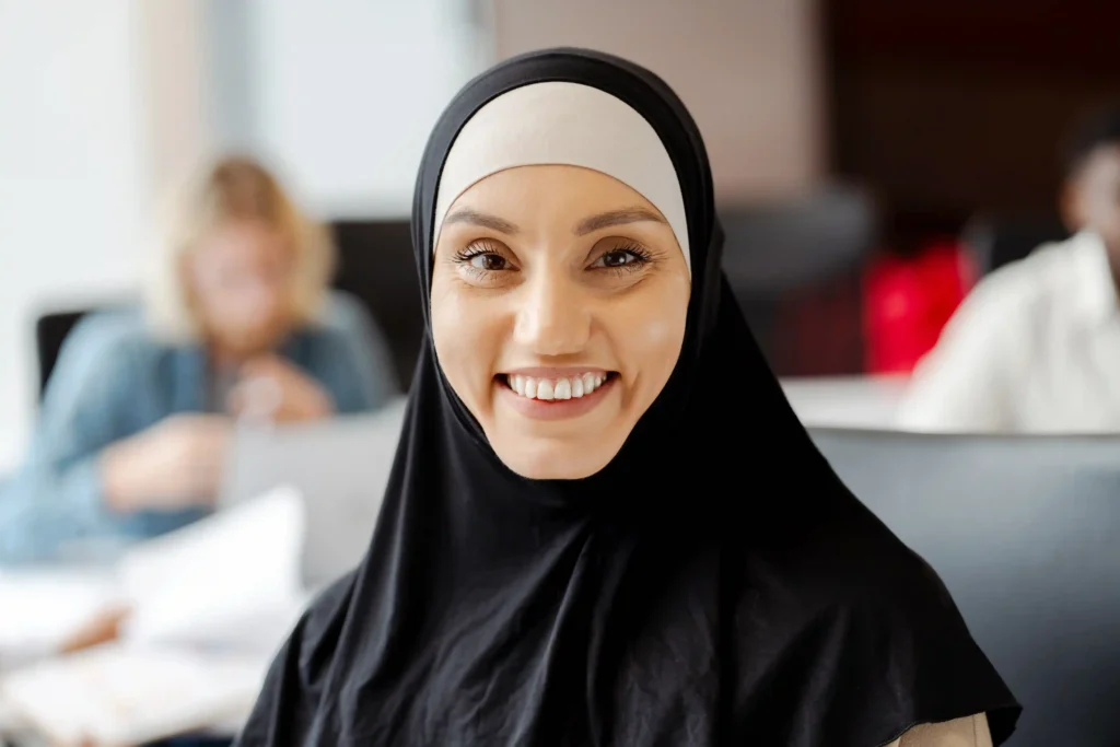 Female Quran Teacher Online for Ladies 6 young muslim woman smiling while working in busy