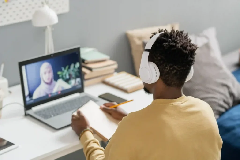 Student attending online class with headphones